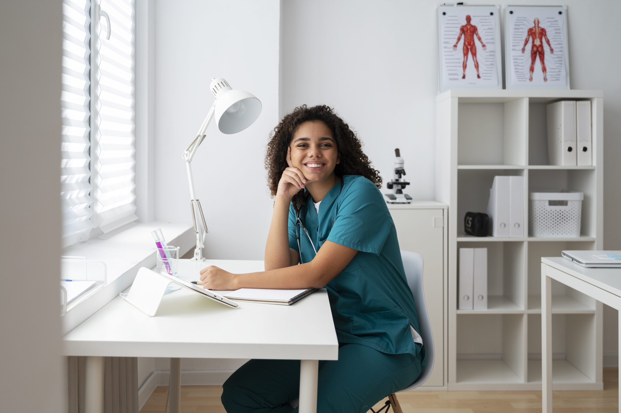 a nurse sat at a desk in medical workwear