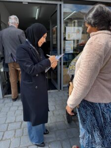 Image of a woman holding a clipboard with another woman standing to her side